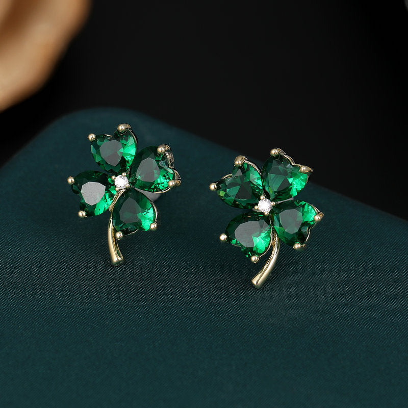 2025 Fresh and sweet super fairy temperament earrings s925 silver needle Korean version niche love-shaped zircon inlaid lucky grass stud earrings