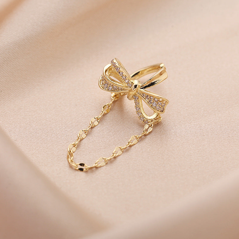 2025 Korean version of fashion tassel earless earrings pendant women's niche personalized earrings bow zircon inlay single earbone clip